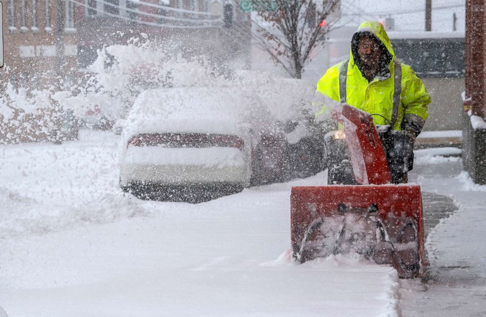 PHOTO: Residents try to keep ahead of the snow with the aid of a snow blower on Church Avenue in Roanoke, Va., Dec. 9, 2018.