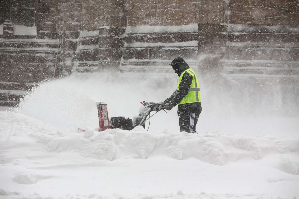PHOTO: A man uses a snow blower to clear snow near Copley Square on Dec. 17, 2020 in Boston.