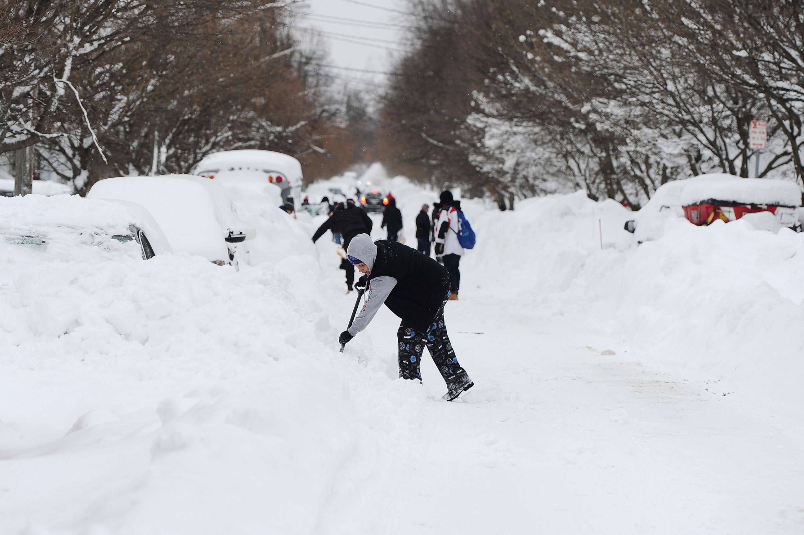 PHOTO: Residents on Woodside Drive clear heavy snow, Dec. 27, 2022, in Buffalo, N.Y.