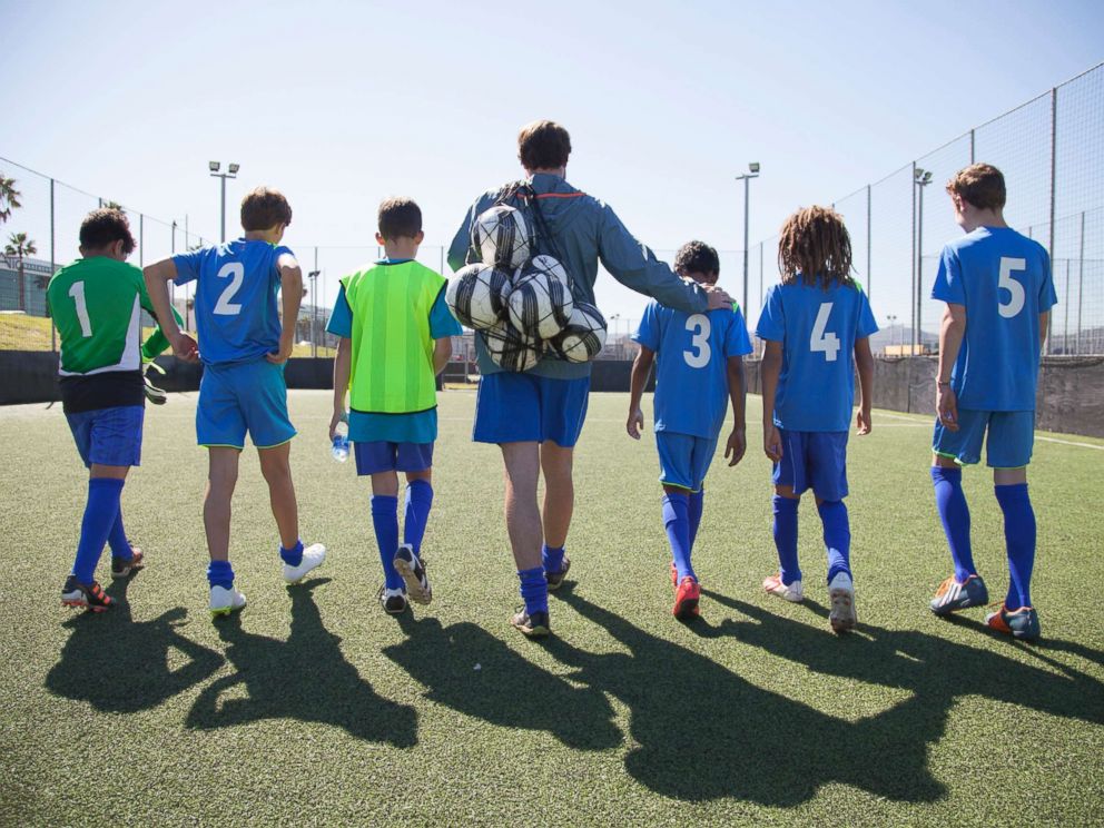 PHOTO: Boys in a soccer team walk out for a game with their coach in this undated stock photo.