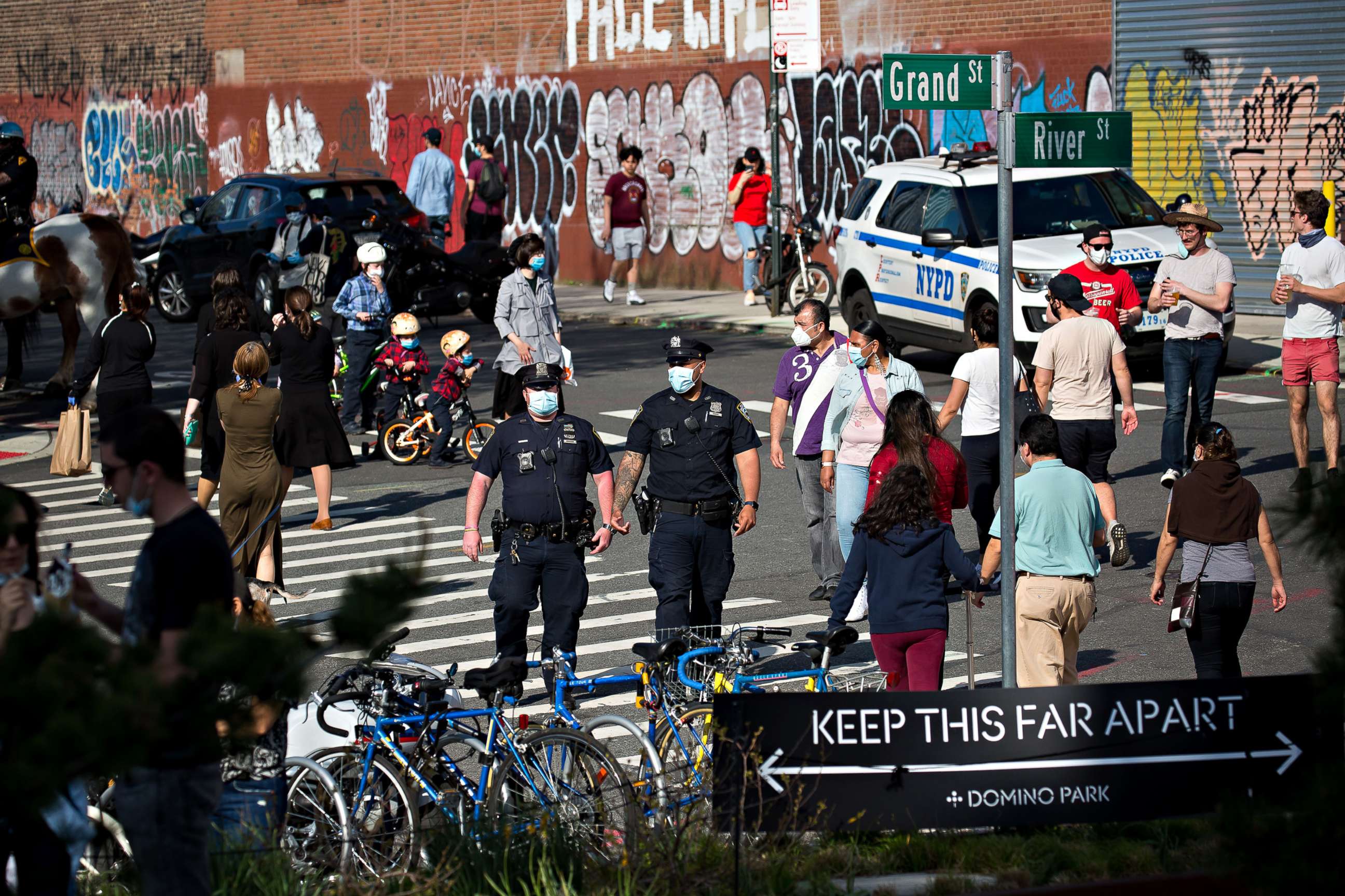 PHOTO: Police officers patrol near a social distancing sign in front of Domino Park during the coronavirus pandemic in the Brooklyn borough of New York City, May 3, 2020.
