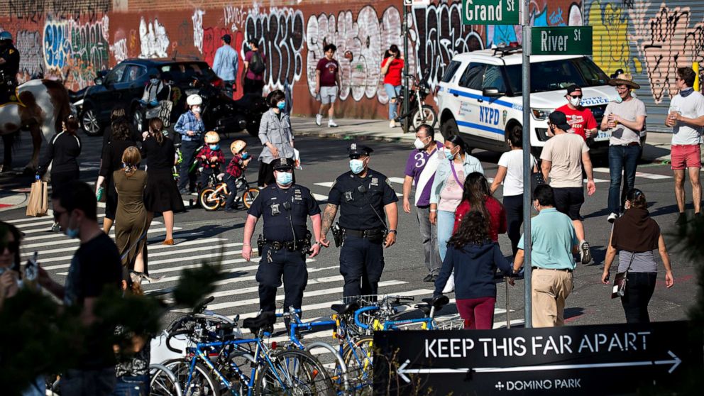 PHOTO: Police officers patrol near a social distancing sign in front of Domino Park during the coronavirus pandemic in the Brooklyn borough of New York City, May 3, 2020.