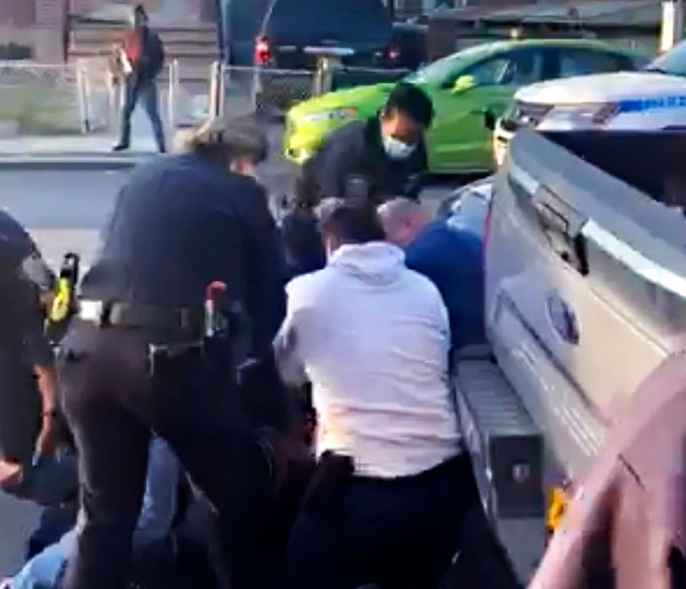 PHOTO: In this April 29, 2020 image from video provided by Adegoke Atunbi, New York City police officers wrestle a man to the ground while making an arrest in the Brooklyn borough of New York City.