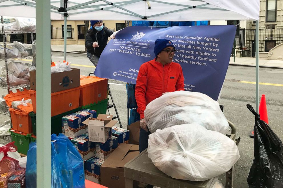 PHOTO: Workers for West Side campaign Against Hunger set up food distribution booth outside St.Paul and St. Andrew United Methodist Church in New York, March 25, 2020.