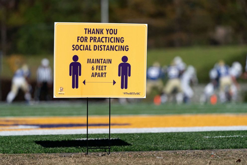 PHOTO: A sign encourages social distancing as Southside Christian plays Lake View during the South Carolina High School League Class A football championship game at Benedict College, Dec. 5, 2020, in Columbia, South Carolina.