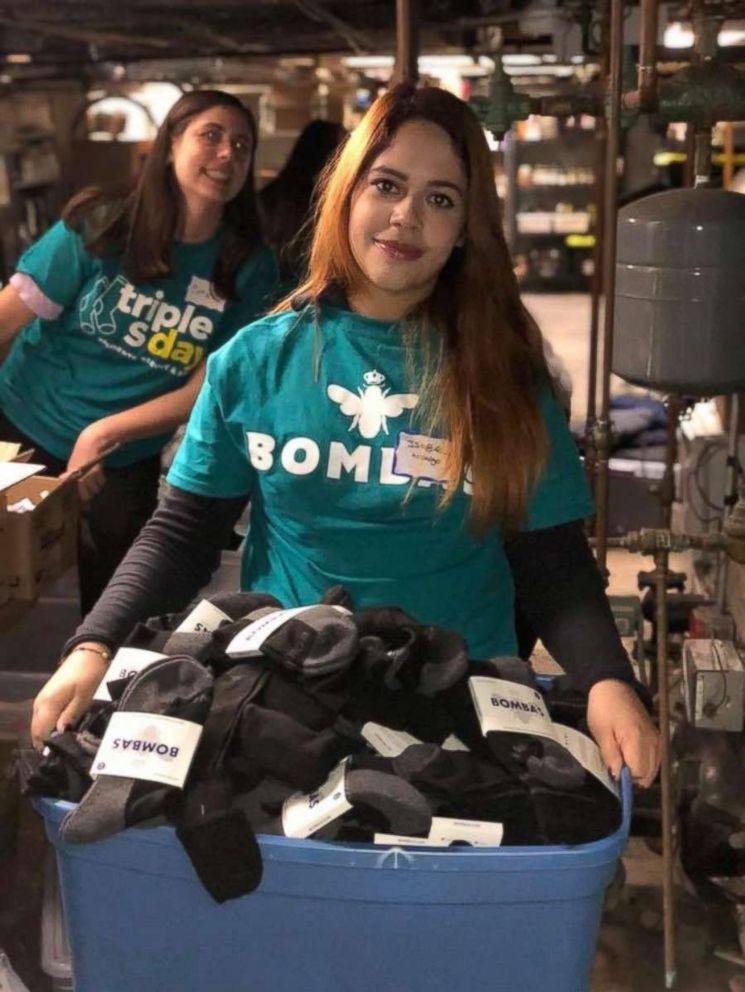 PHOTO: Two college students are photographed organizing Bombas socks to donate.