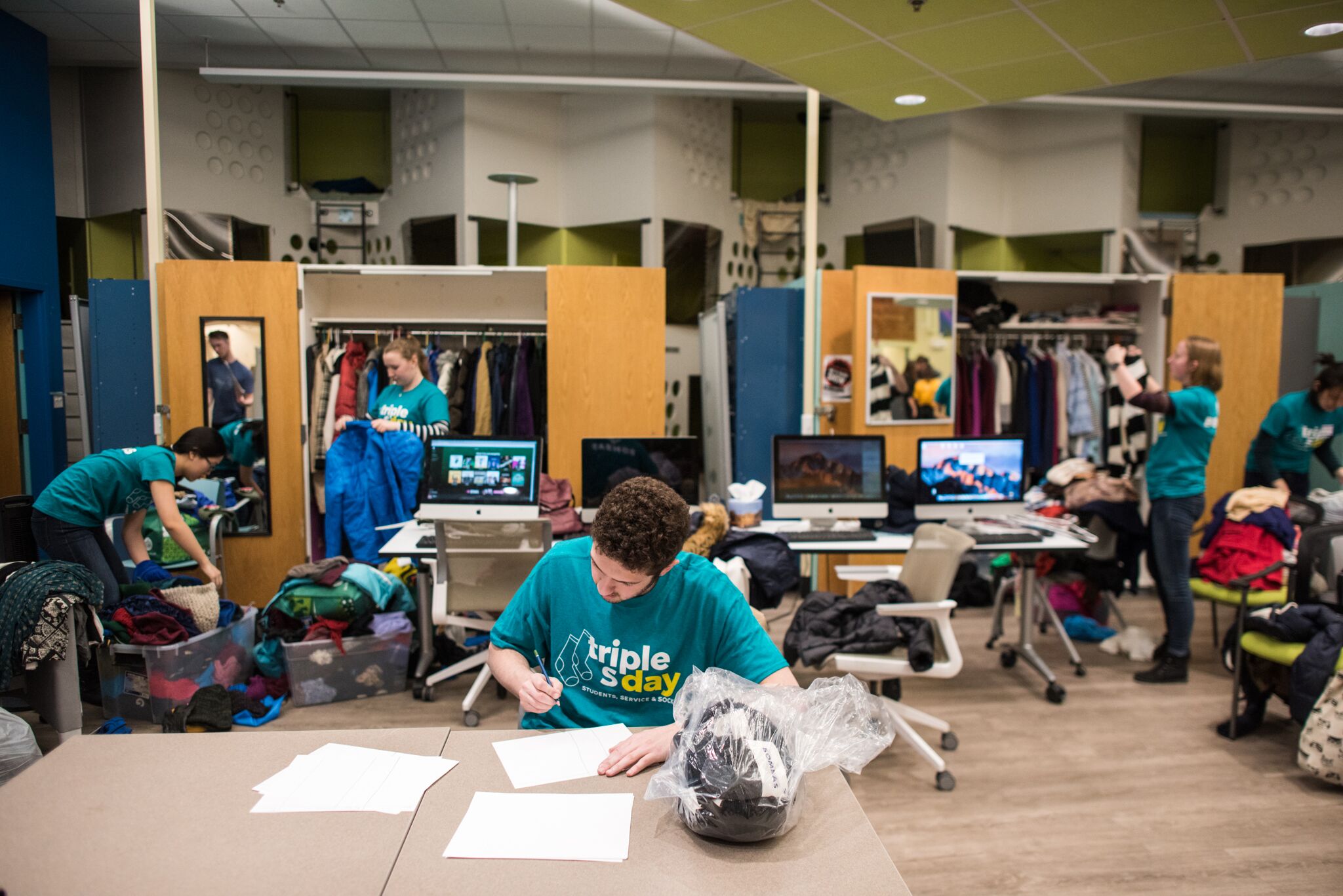 PHOTO: Boston-area college students help organize donated clothing items at a Boston homeless shelter.