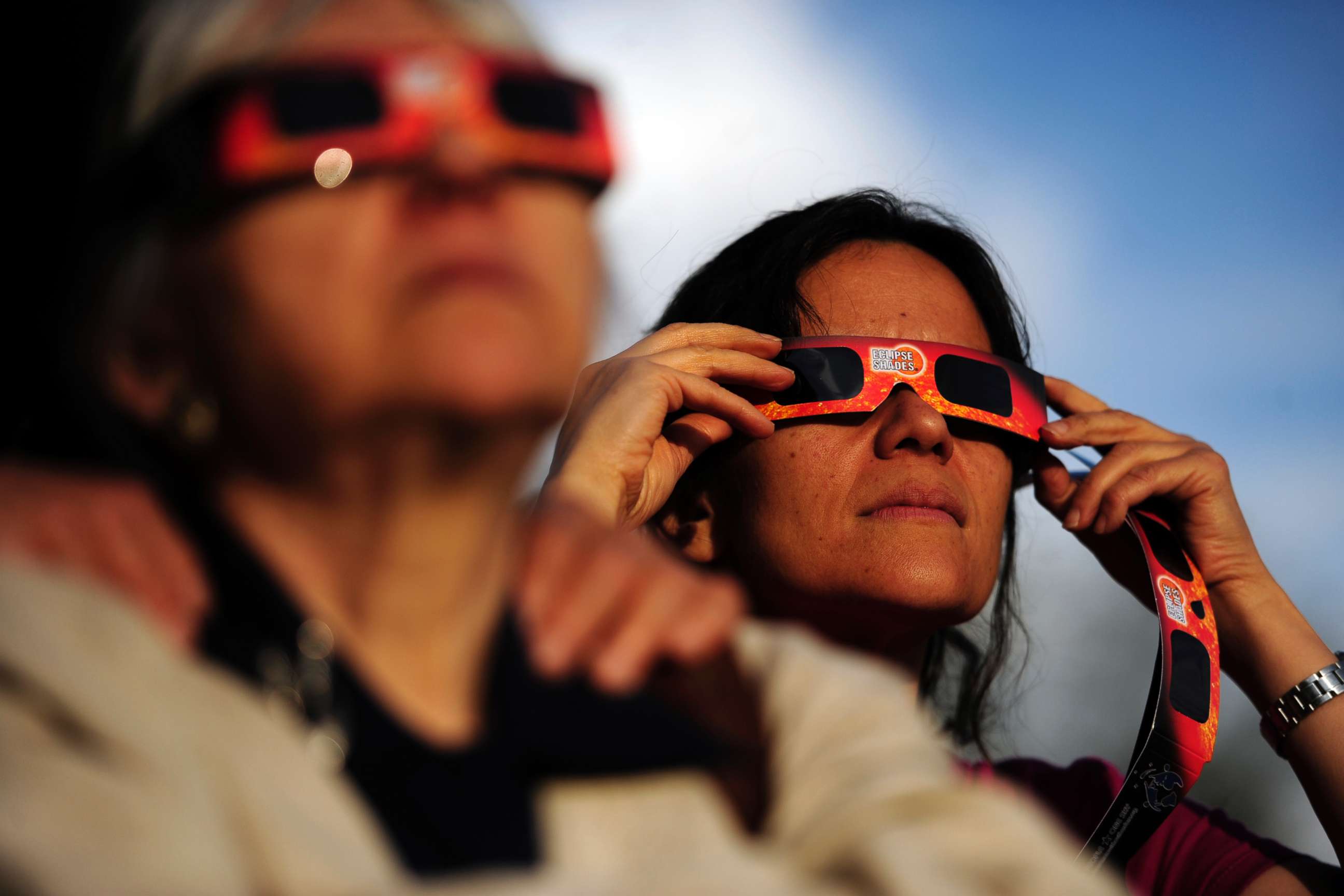 PHOTO: Ina Schakaraschwili holds her glasses in place during a solar eclipse at the University of Denver's Chamberlain Observatory in this May 20, 2012 file photo