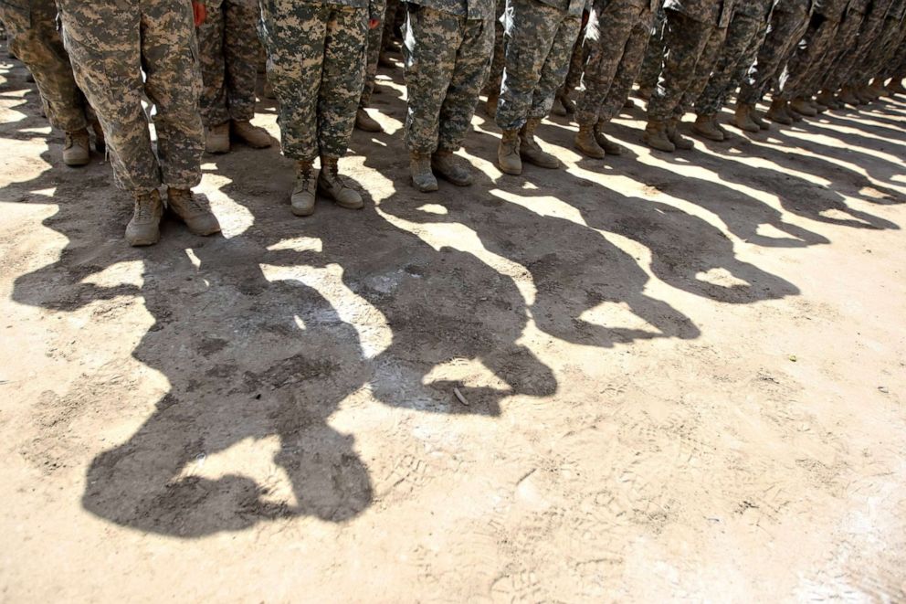 PHOTO: U.S. soldiers salute in Baghdad, Iraq. on June 1, 2010.