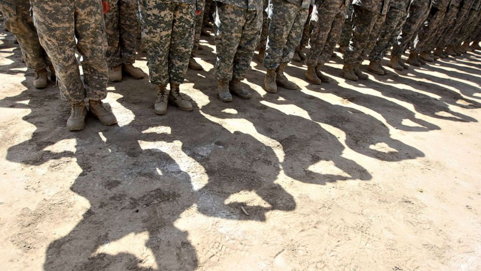 PHOTO: U.S. soldiers salute in Baghdad, Iraq. on June 1, 2010.