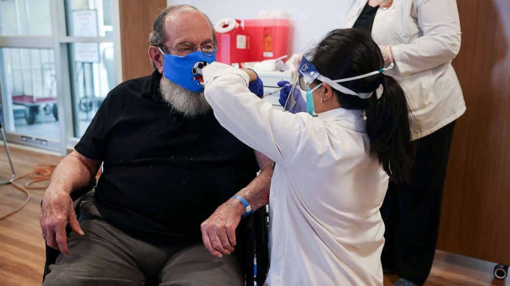 PHOTO: U.S. Air Force veteran Robert Aucoin, 78, receives a coronavirus disease vaccine dose at the Soldiers' Home in Holyoke, Mass., Dec. 29, 2020.