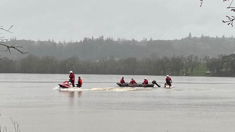 PHOTO: Rescue personnel search for a car and driver stuck in flood waters in Forestville, Calif. Jan. 11, 2023.