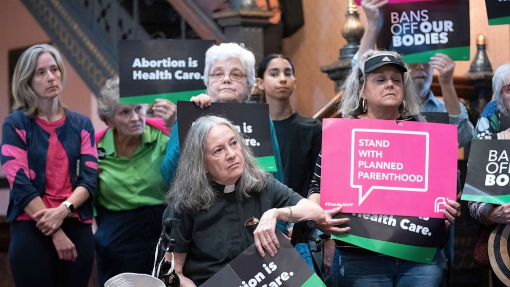 PHOTO: Demonstrators gather with placards and signs in the lobby of the South Carolina Statehouse, May 16, 2023, in Columbia, S.C.