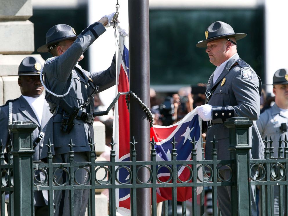 PHOTO: In this Friday, July 10, 2015, file photo, an honor guard from the South Carolina Highway patrol lowers the Confederate battle flag as it is removed from the Capitol grounds in Columbia, S.C.