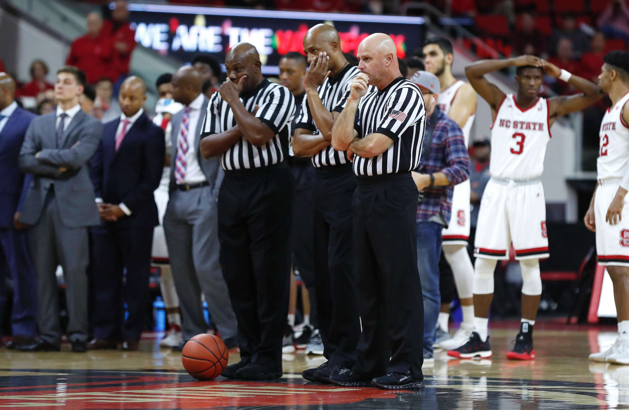 PHOTO: Game 0fficials including from left, Les Jones, Bert Smith and Tim Comer, watch as South Carolina State's Tyvoris Solomon is attended to after he was injured during an NCAA college basketball at PNC Arena in Raleigh, N.C., Dec. 2, 2017.  