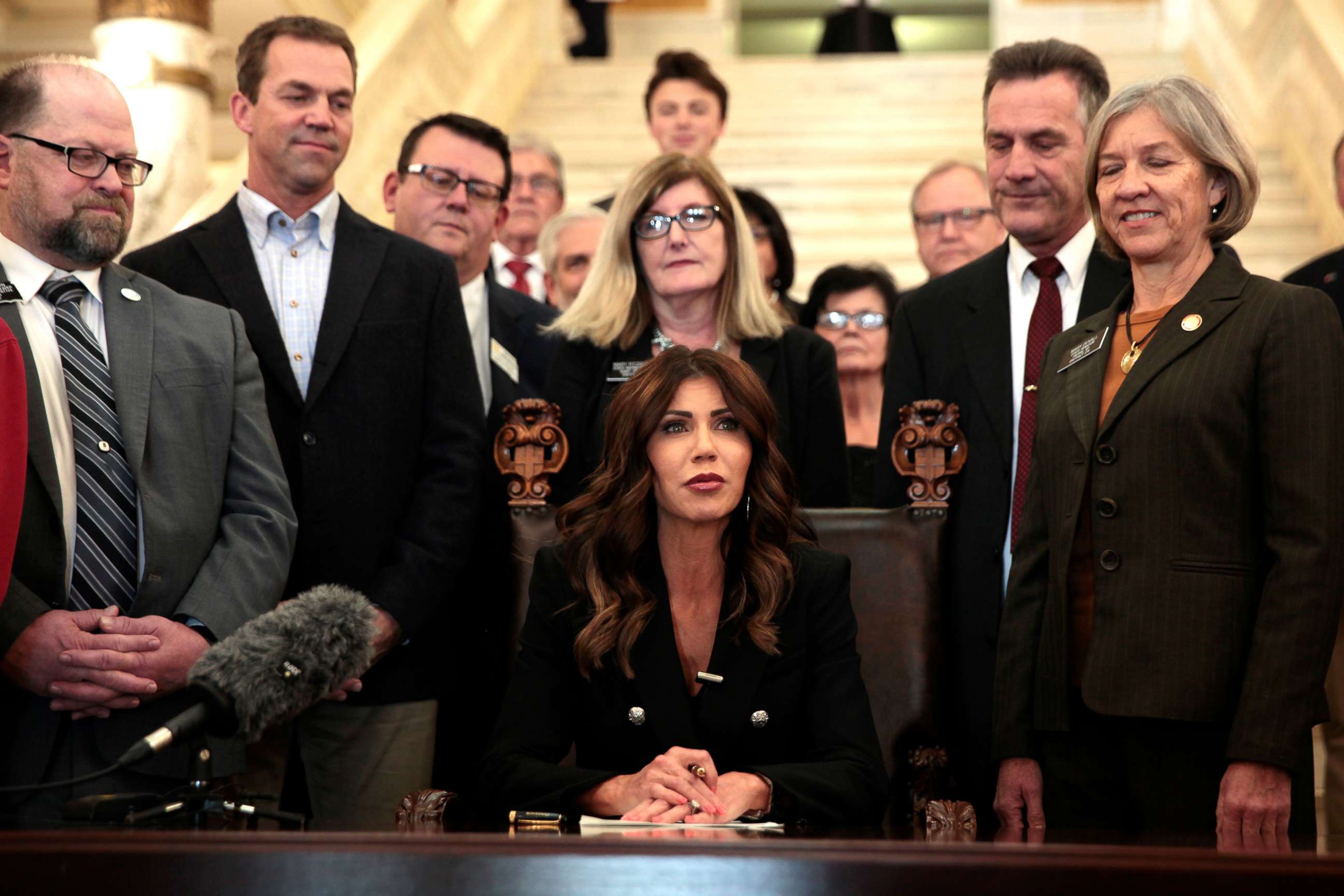 PHOTO: South Dakota Gov. Kristi Noem signs a bill Thursday, Feb. 3, 2022, at the state Capitol in Pierre, S.D., that will ban transgender women and girls from playing in school sports leagues that match their gender identity.