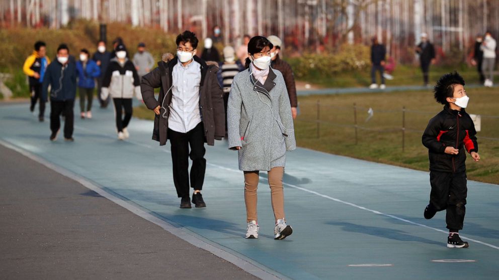 PHOTO: People wearing masks to avoid the spread of the coronavirus disease (COVID-19) walk on a track as they work out at a park in Seoul, South Korea, April 24, 2020.