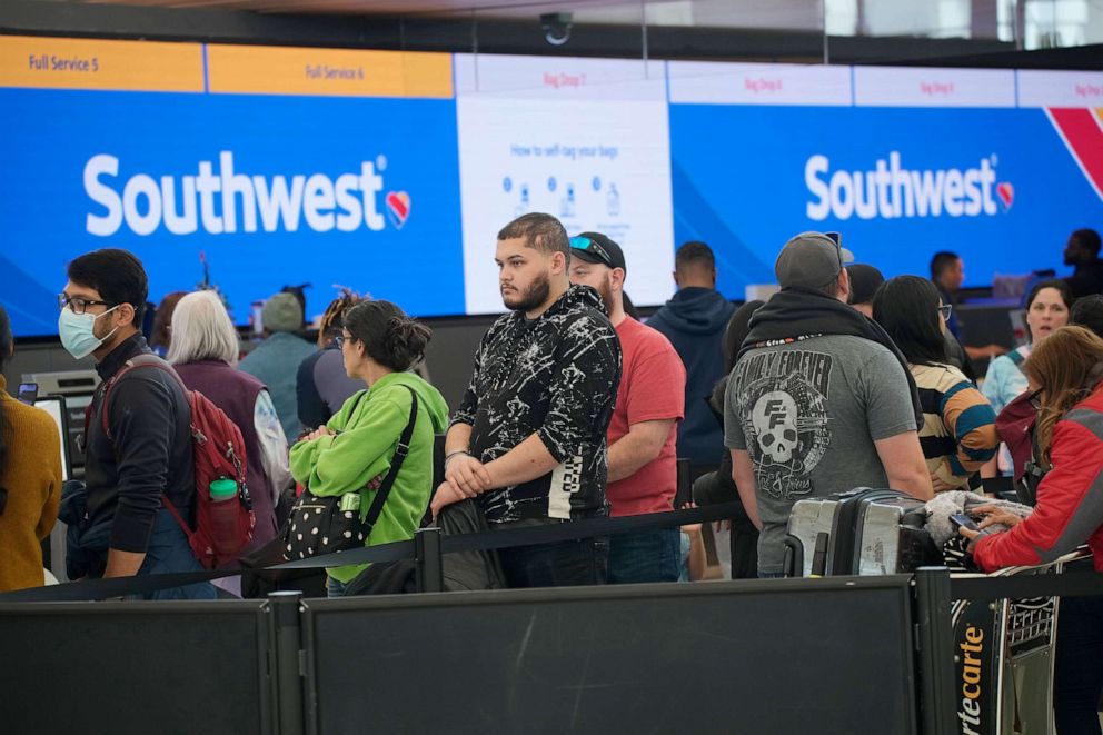 PHOTO: Travelers wade through the line for service to drop off bags at the Southwest Airlines check-in counter in Denver International Airport, Dec. 27, 2022, in Denver.