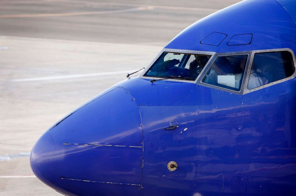 PHOTO: Southwest Airlines Co. pilots conduct a pre-flight check in the cockpit of an airplane on the tarmac at Los Angeles International Airport, Sept. 6, 2013.