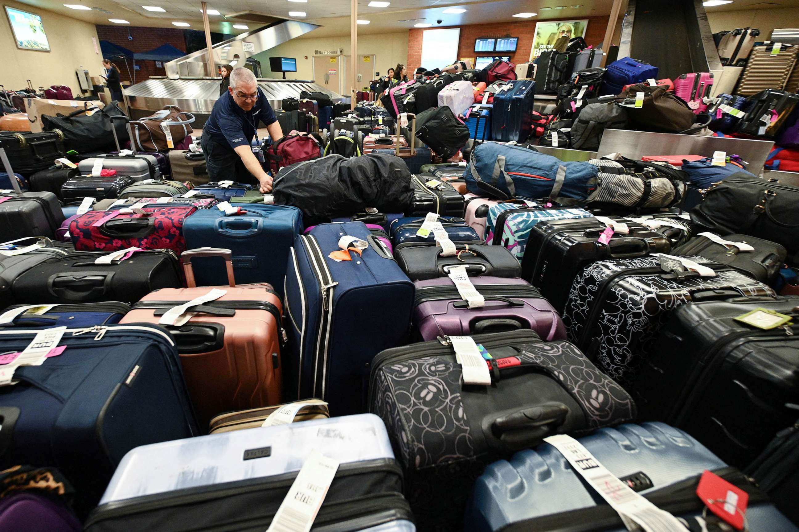 PHOTO: A Southwest Airlines employee sorts through unclaimed luggage at Hollywood Burbank Airport in Burbank, California, Dec. 27, 2022.