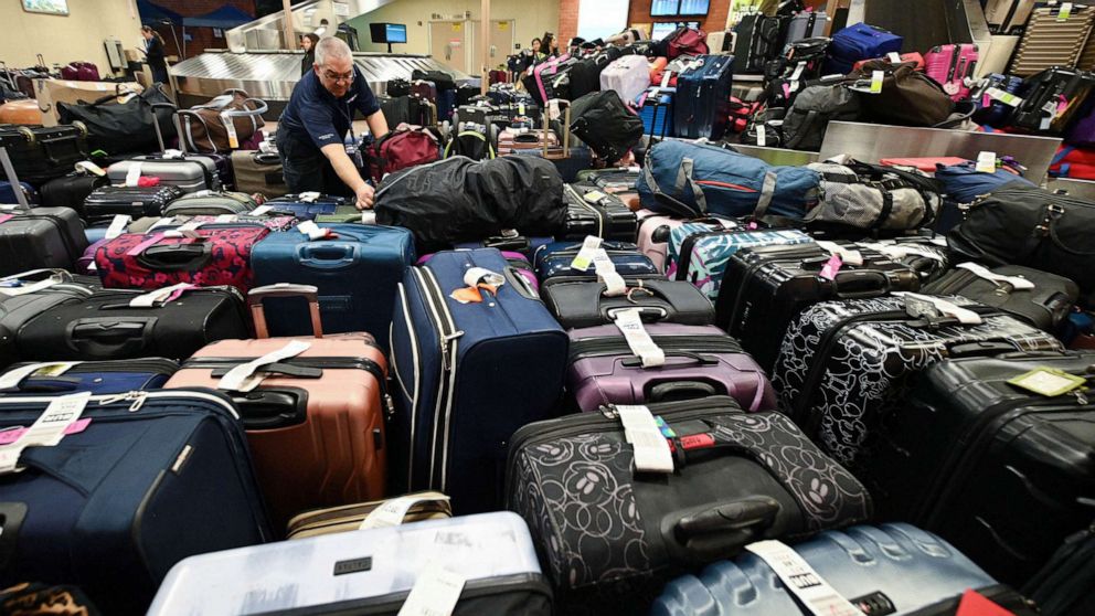 PHOTO: A Southwest Airlines employee sorts through unclaimed luggage at Hollywood Burbank Airport in Burbank, California, Dec. 27, 2022.