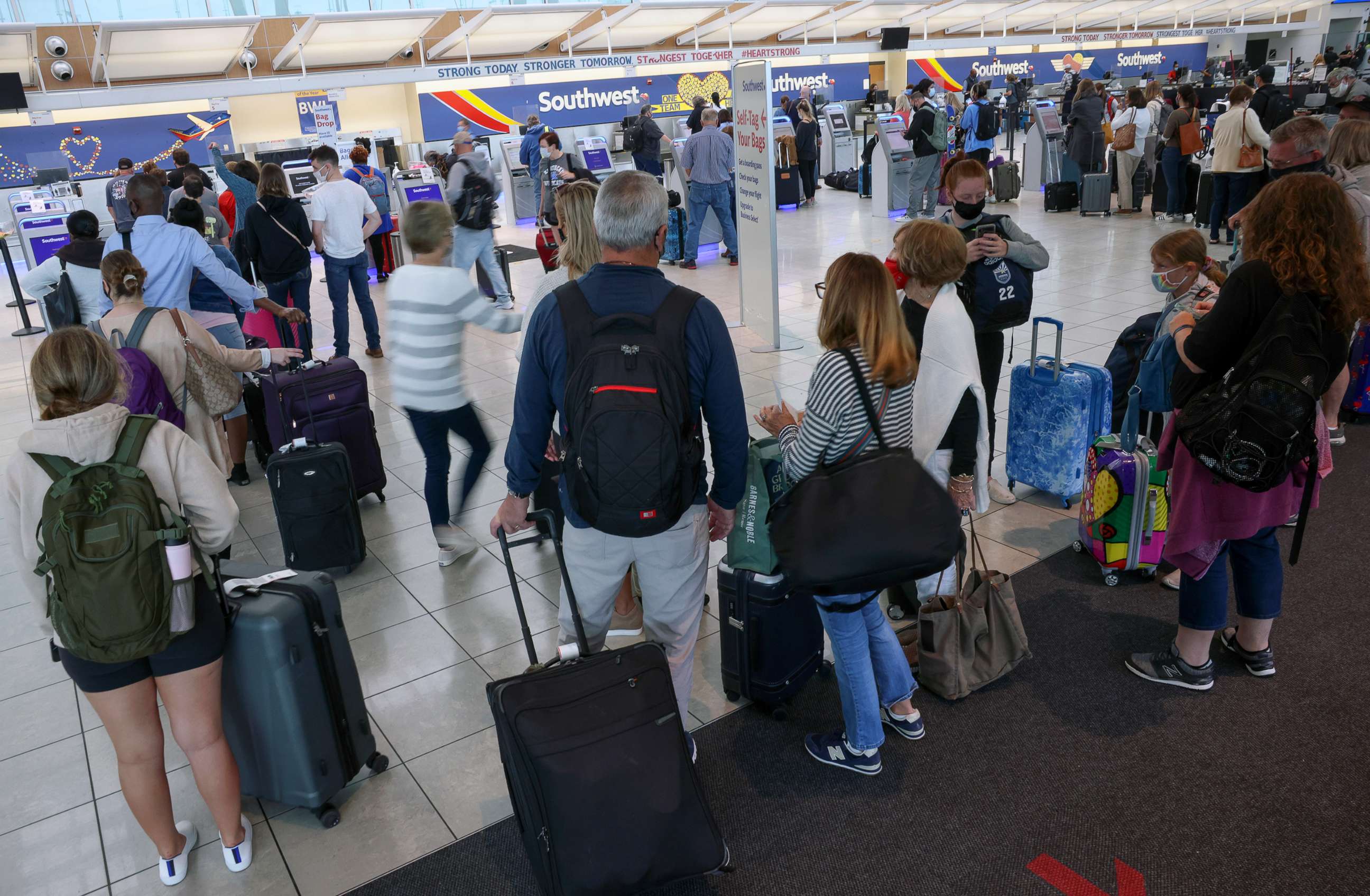 PHOTO: Travelers wait to check in at the Southwest Airlines ticketing counter at Baltimore Washington International Thurgood Marshall Airport, Oct. 11, 2021, in Baltimore.