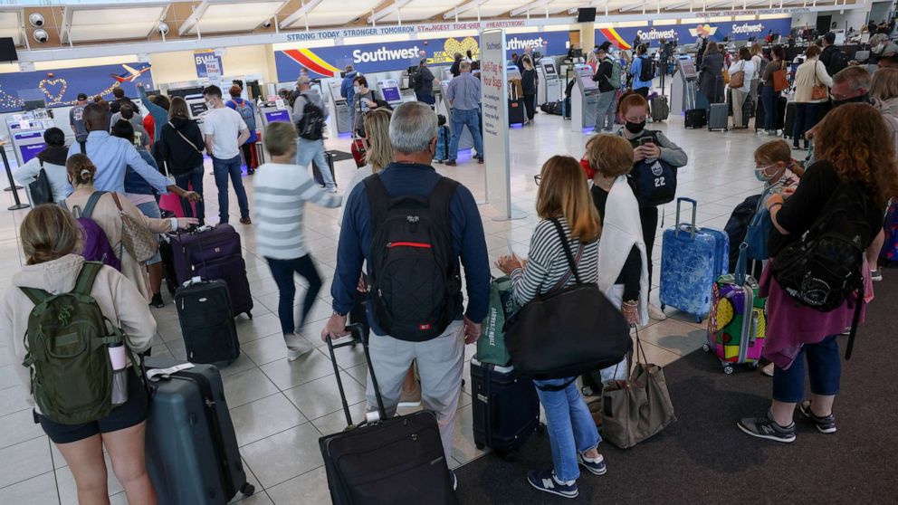 PHOTO: Travelers wait to check in at the Southwest Airlines ticketing counter at Baltimore Washington International Thurgood Marshall Airport, Oct. 11, 2021, in Baltimore.