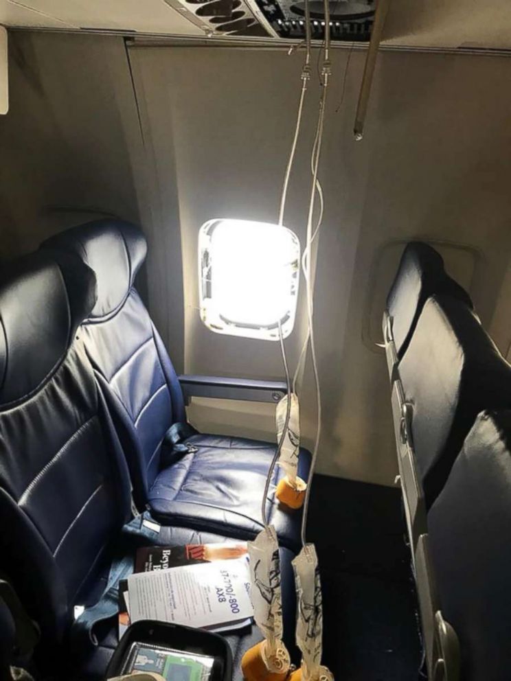 PHOTO: Oxygen masks and a blown out window are seen from inside a Southwest Airlines plane after an emergency landing at the Philadelphia airport, April 17, 2018.