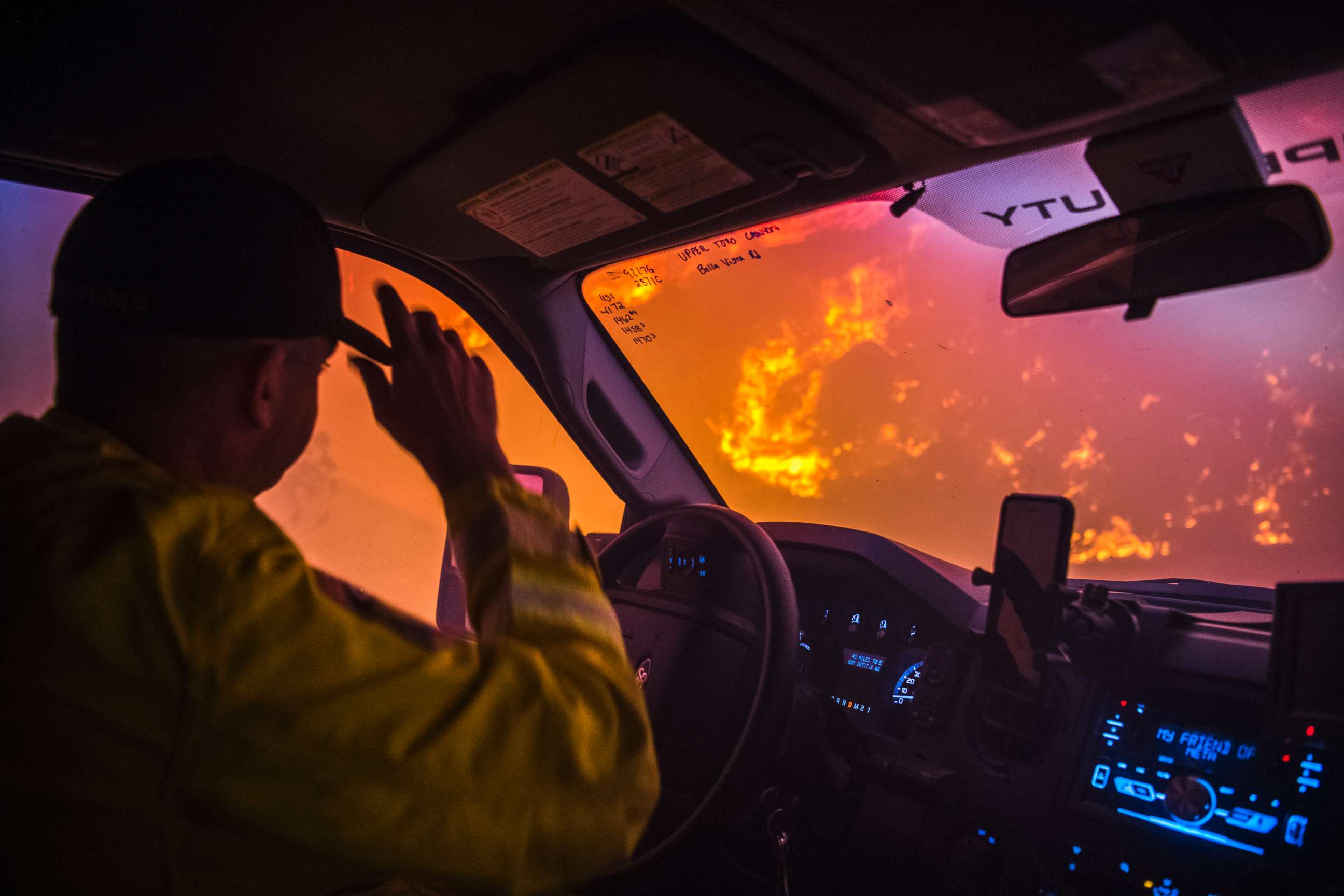 PHOTO: Cal Fire battalion chief and strike team leader Gino DeGraffenreid drives past a flaming hillside while checking on homes Monday night in Toro Canyon, Calif. at the Thomas Fire on Dec. 11, 2017.
