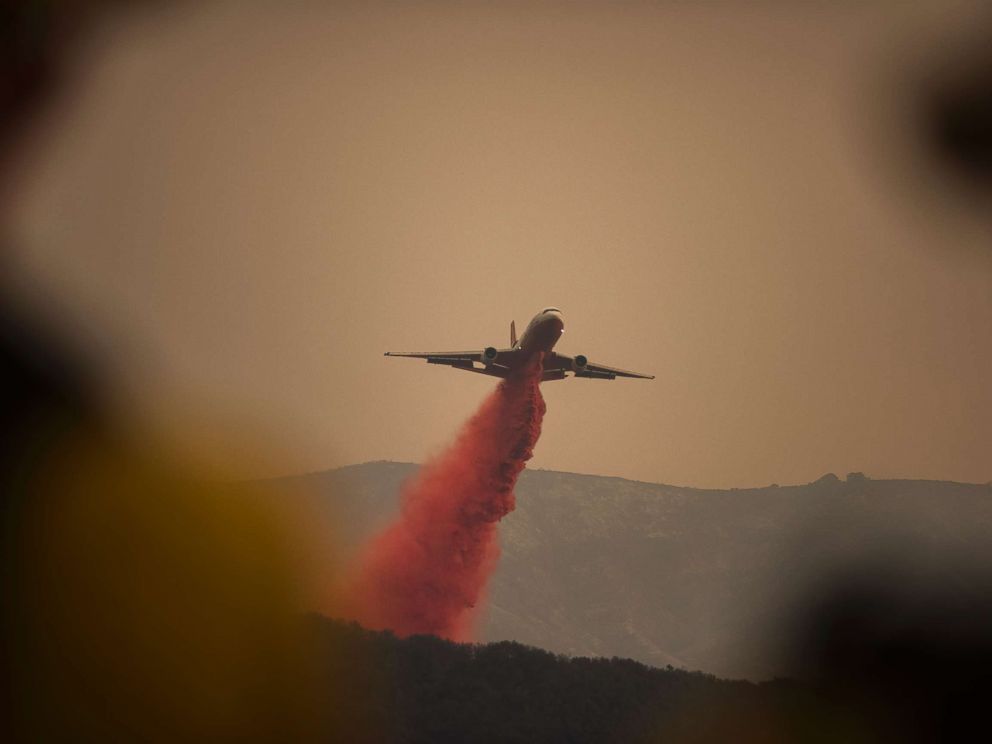 PHOTO: A DC-10 jet, or VLAT (Very Larger Air Tanker) drops fire retardant in Toro Canyon, Calif. on Monday afternoon, Dec. 11, 2017, before anticipated winds caused the fire to burn downhill.