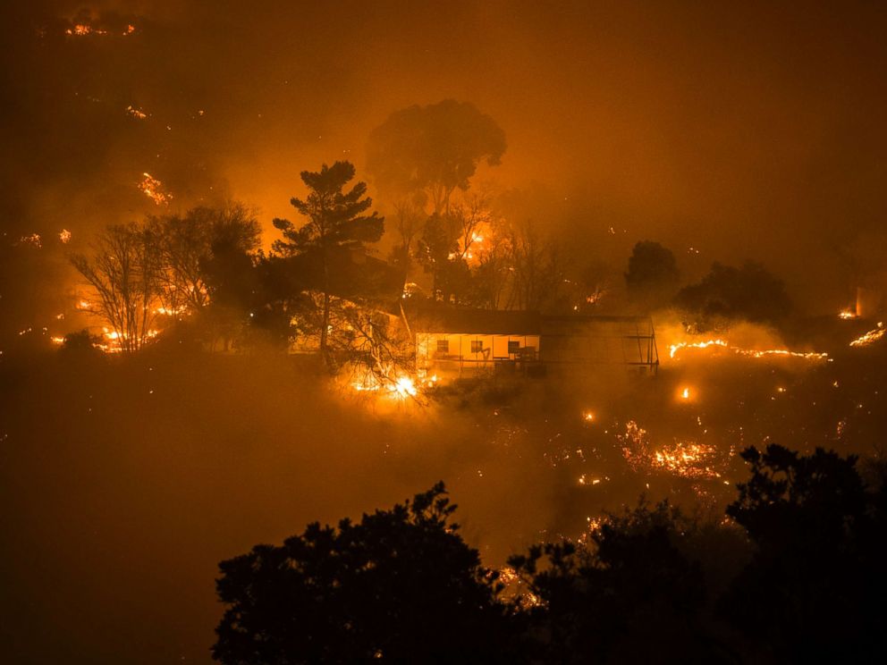 PHOTO: A home surrounded by fire in Toro Canyon, Calif. on Dec. 11, 2017. Firefighters saved the home with minutes to spare but some outbuildings and a vehicle were burned.