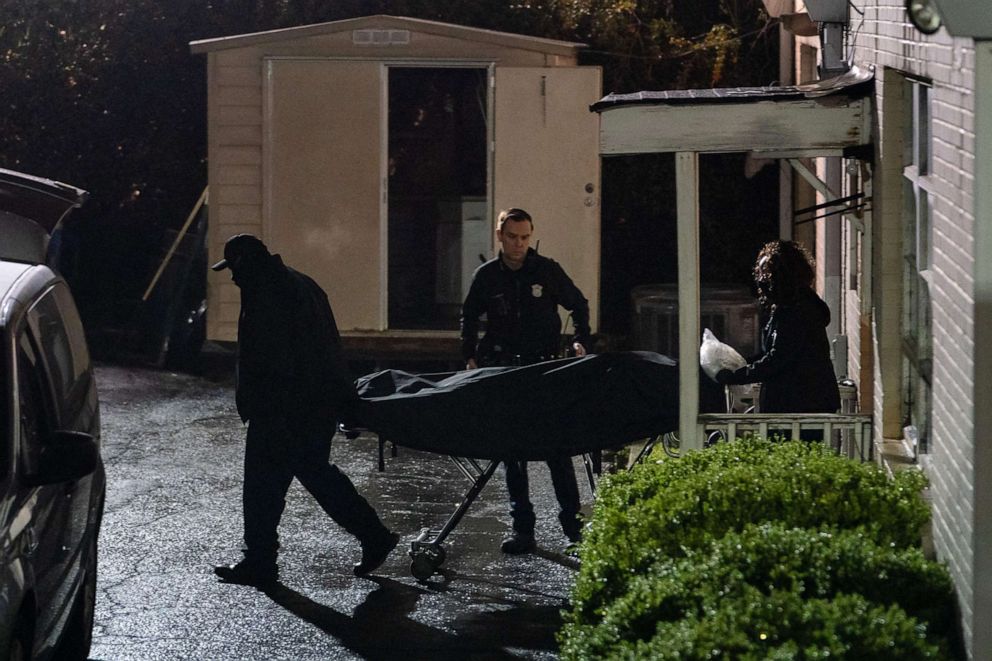 PHOTO: People with the medical examiner's office wheel out a body on a stretcher from a spa where three people were shot and killed on March 16, 2021, in Atlanta. 