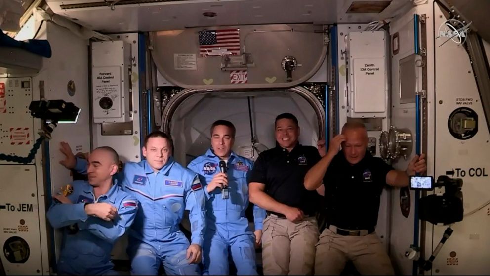 PHOTO: NASA SpaceXs Crew Dragon astronauts Douglas Hurley, right, and Robert Behnken pose with other astronauts after arriving to the International Space Station, May 31, 2020.