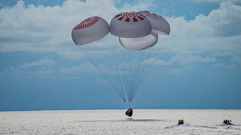 PHOTO: In this image taken provided by SpaceX, a capsule carrying four people parachutes into the Atlantic Ocean off the Florida coast, Saturday, Sept. 18, 2021. The all-amateur crew was the first to circle the world without a professional astronaut.