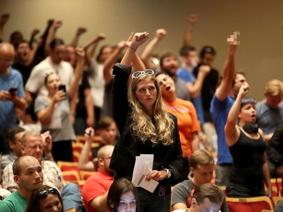 PHOTO: People react as white nationalist Richard Spencer, who popularized the term alt-right speaks at the Curtis M. Phillips Center for the Performing Arts, Oct. 19, 2017, in Gainesville, Florida.