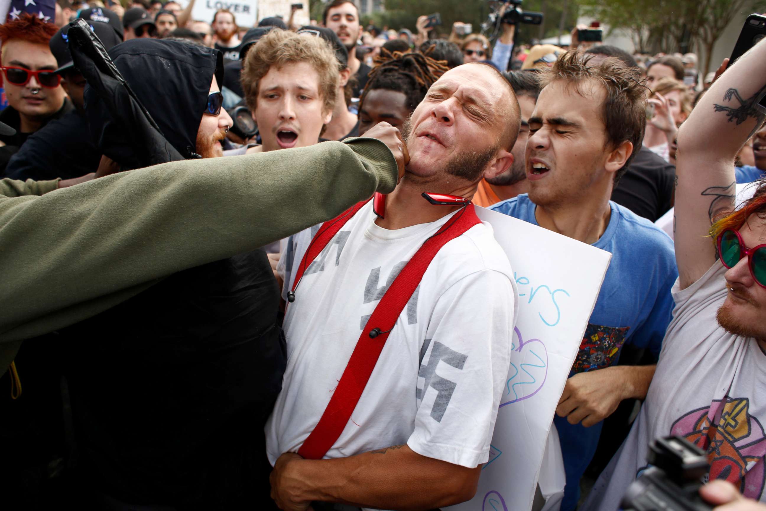 PHOTO: A man wearing a shirt with swastikas on it is punched by an unidentified member of the crowd near the site of a planned speech by white nationalist Richard Spencer at the University of Florida campus, Oct. 19, 2017, in Gainesville, Florida.