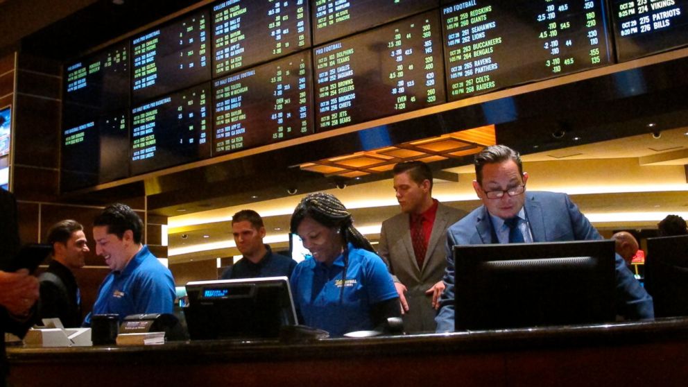 PHOTO: This Oct. 25, 2018 photo shows employees at the new sports book at the Tropicana casino in Atlantic City N.J., preparing to take bets moments before it opened.