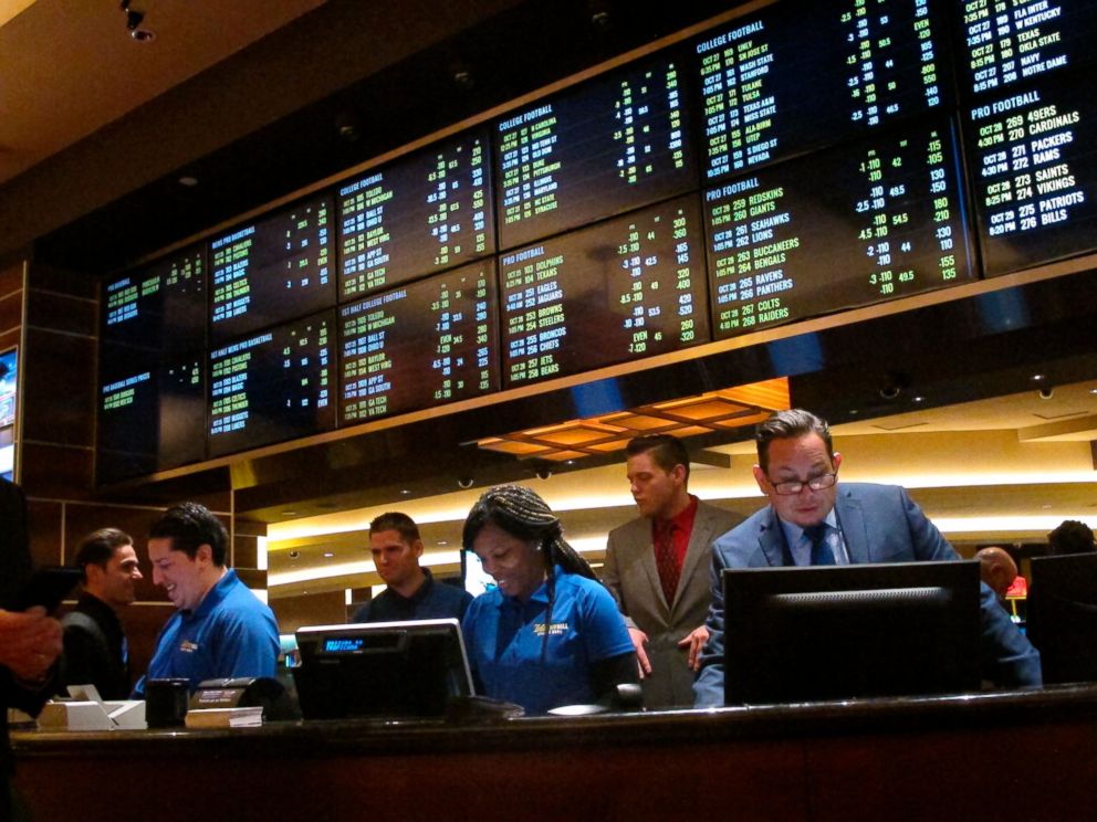 PHOTO: This Oct. 25, 2018 photo shows employees at the new sports book at the Tropicana casino in Atlantic City N.J., preparing to take bets moments before it opened.