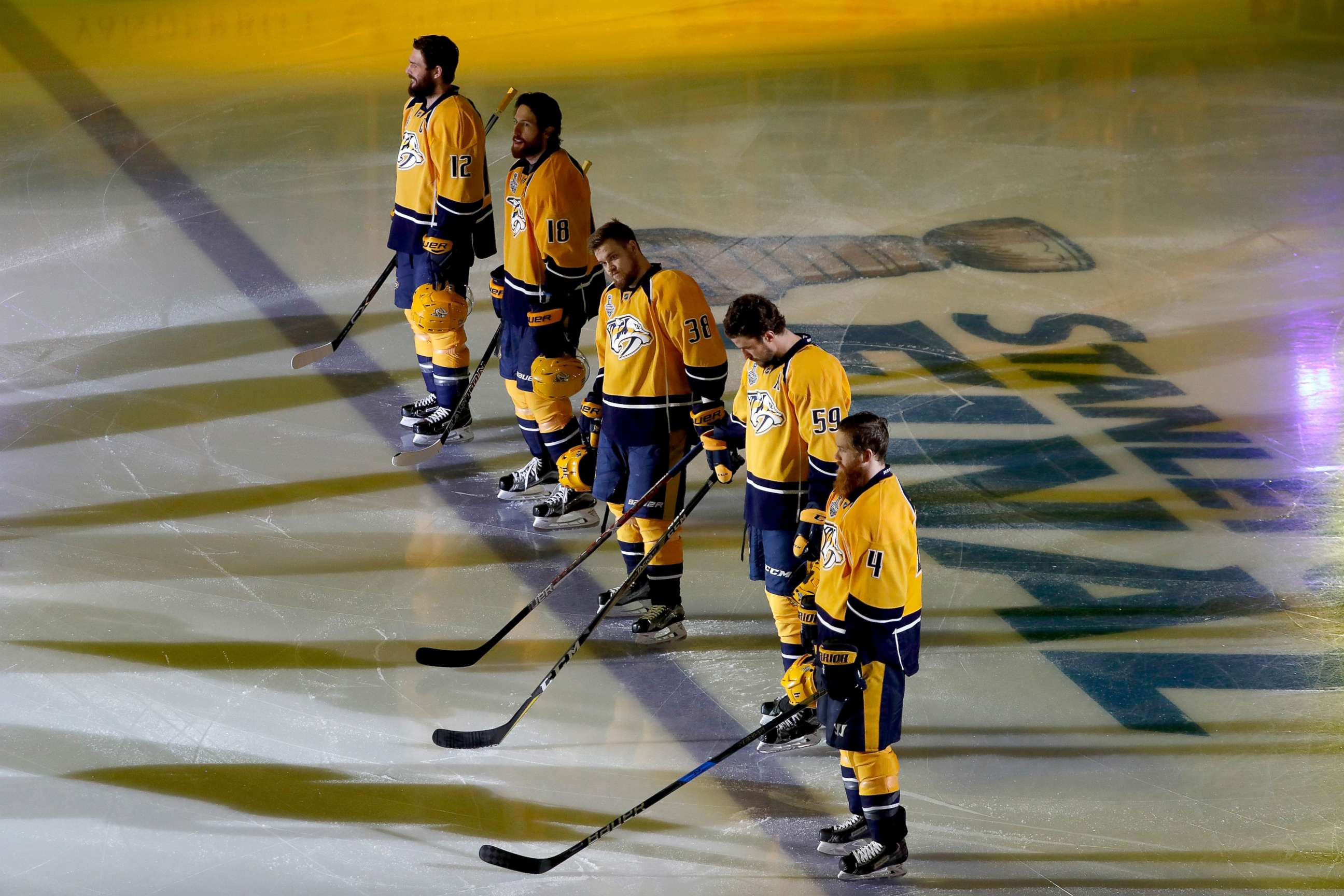 PHOTO: Nashville Predators players stand on the ice during the national anthem prior to Game Three of the 2017 NHL Stanley Cup Final against the Pittsburgh Penguins at the Bridgestone Arena, June 3, 2017, in Nashville.