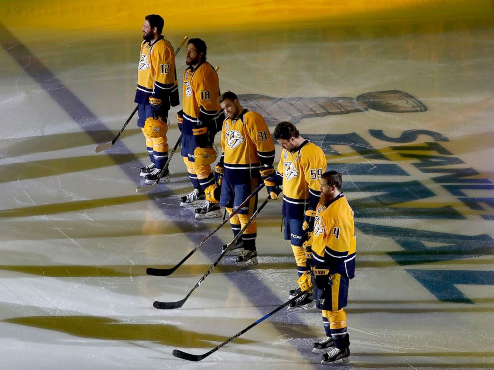 PHOTO: Nashville Predators players stand on the ice during the national anthem prior to Game Three of the 2017 NHL Stanley Cup Final against the Pittsburgh Penguins at the Bridgestone Arena, June 3, 2017, in Nashville.