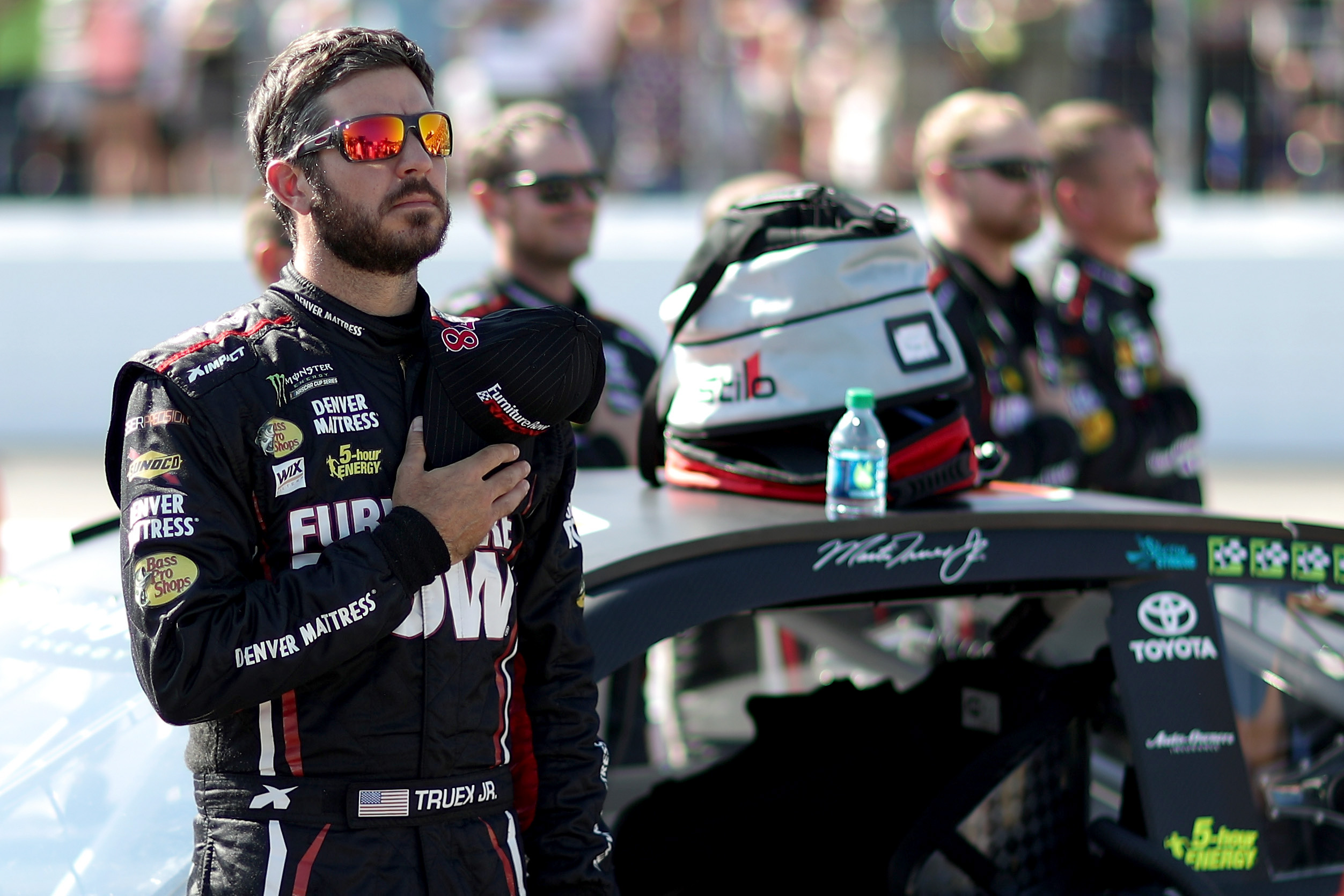PHOTO: Martin Truex Jr.stands during the national anthem prior to the Monster Energy NASCAR Cup Series ISM Connect 300 at New Hampshire Motor Speedway, Sept. 24, 2017, in Loudon, New Hampshire. 