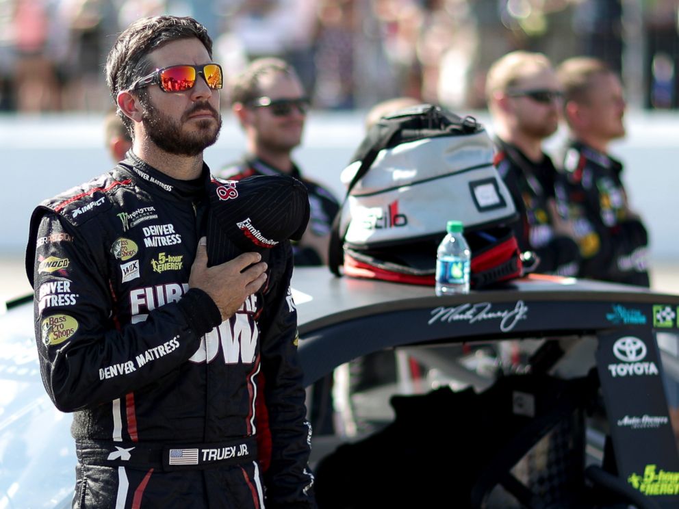 PHOTO: Martin Truex Jr.stands during the national anthem prior to the Monster Energy NASCAR Cup Series ISM Connect 300 at New Hampshire Motor Speedway, Sept. 24, 2017, in Loudon, New Hampshire.