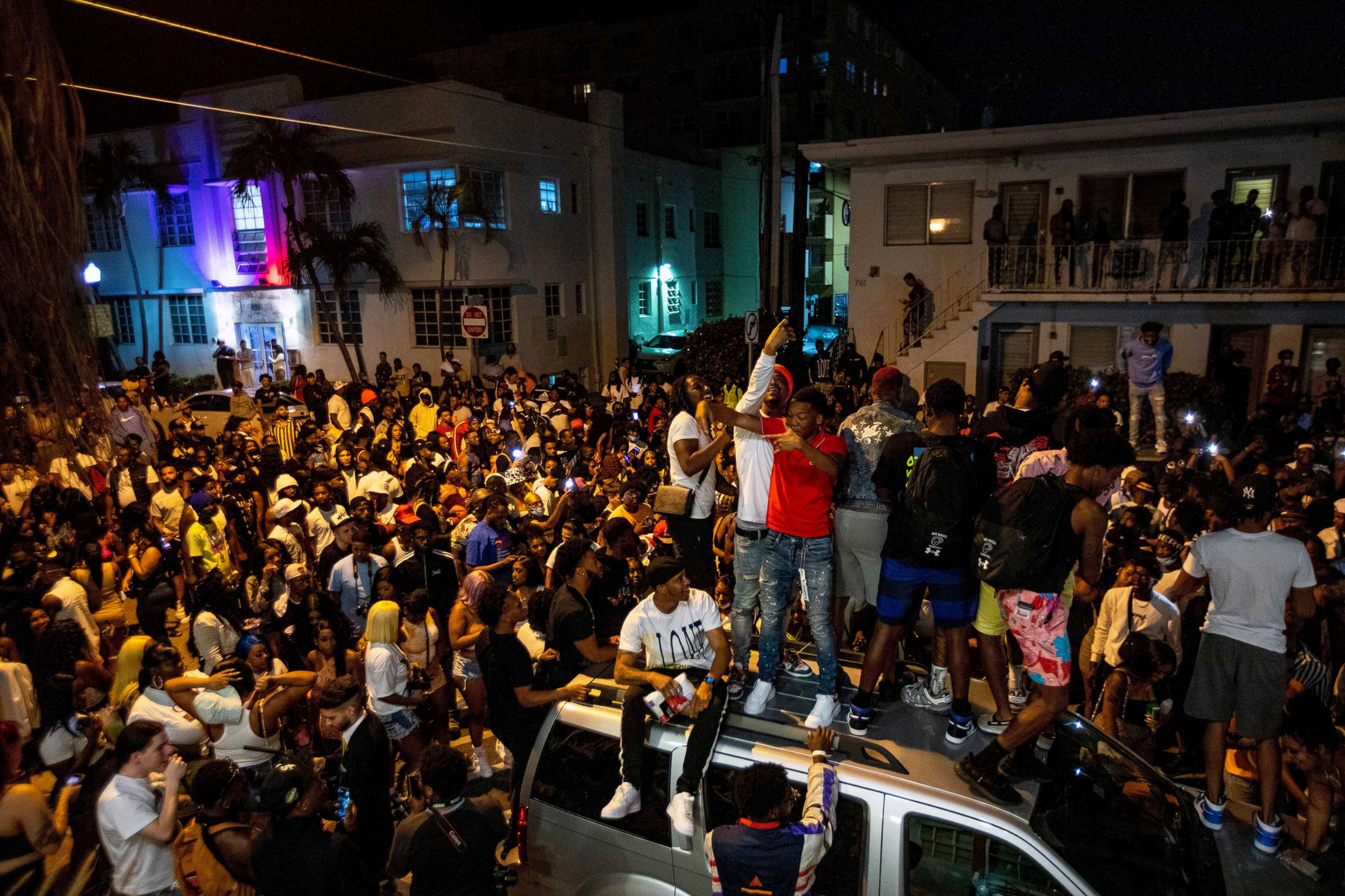 PHOTO: Crowds defiantly gather in the street while a speaker blasts music an hour past curfew in Miami Beach, Fla., March 21, 2021.