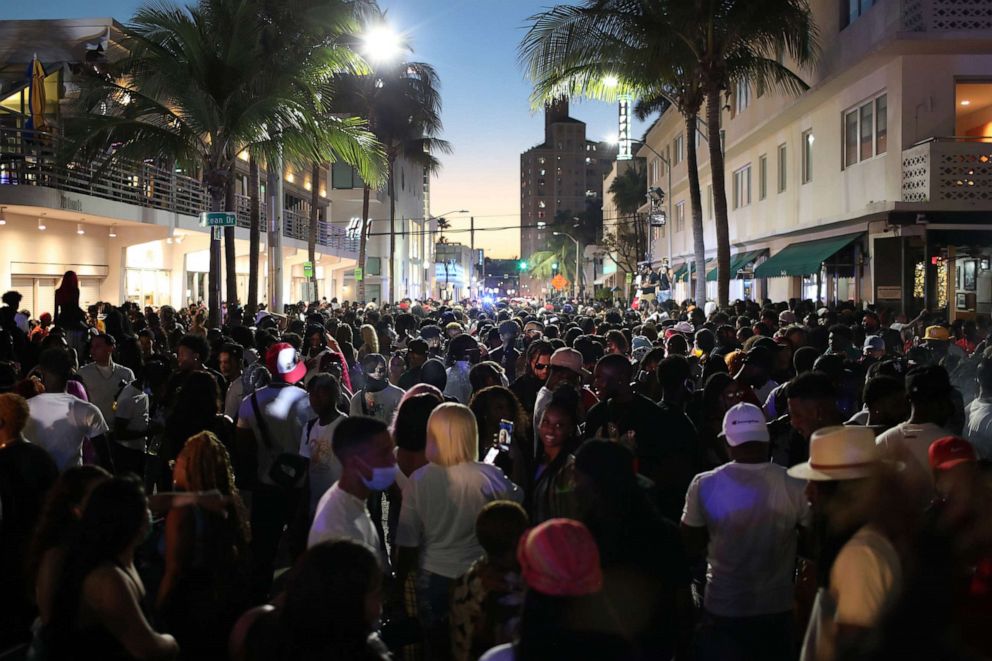 PHOTO: People walk along Ocean Drive on March 21, 2021 in Miami Beach, Fla.