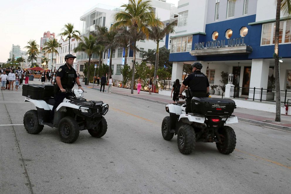 PHOTO: Miami Beach police officers patrol along Ocean Drive on March 21, 2021 in Miami Beach, Fla.