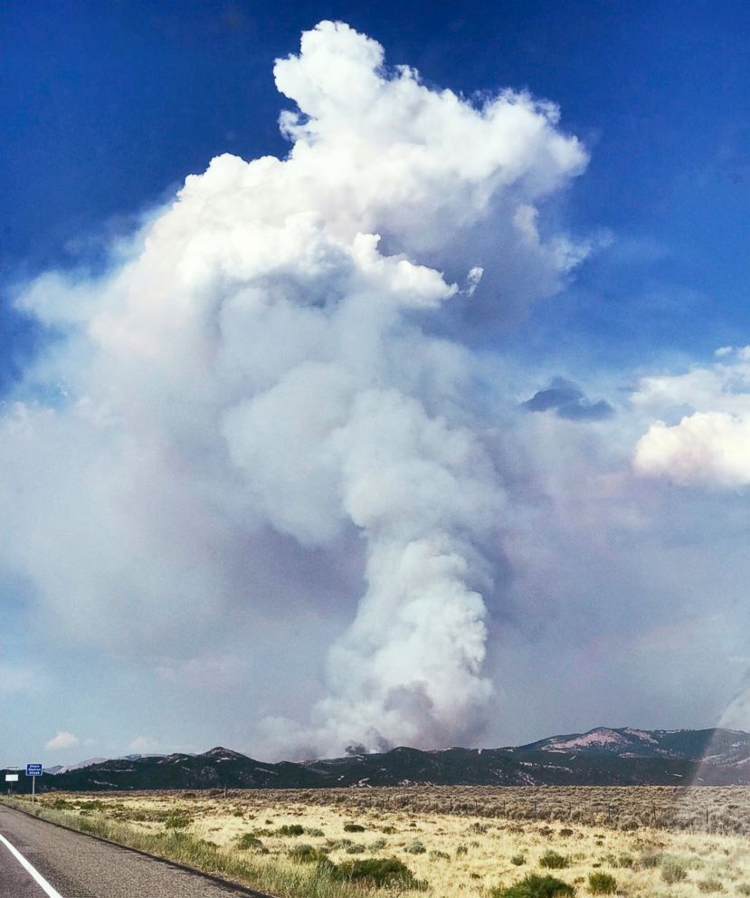 Smoke looms near La Veta Pass in Costillo County in southern Colorado, from one of several wildfires burning in Colorado and Utah, Thursday, June 28, 2018. Authorities say some structures have been burned by what is called the Spring Fire.