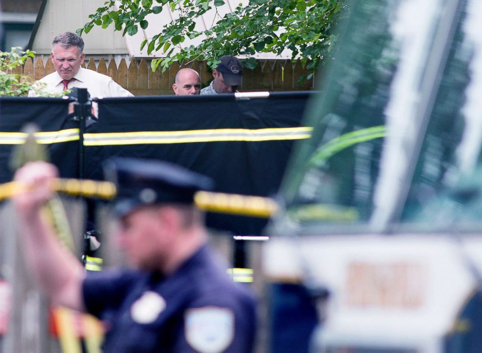 PHOTO: Investigators search a yard of a Page Boulevard home after three bodies were found in Springfield, Mass., June 1, 2018.