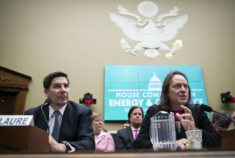 PHOTO: John Legere, chief executive officer of T-Mobile US Inc., right, speaks as Marcelo Claure, chairman of Sprint Corp, listens during a hearing on the the T-Mobile and Sprint merger on Capitol Hill, Feb. 13, 2019. 