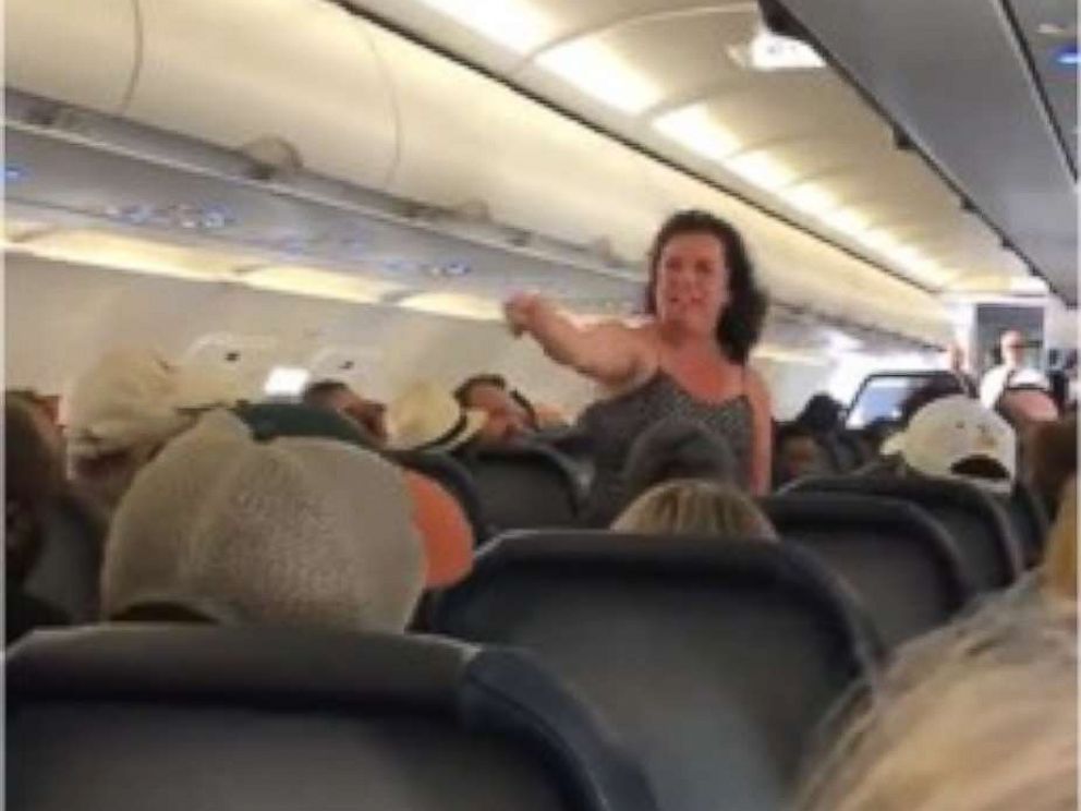 A woman was removed from a robbery after she unleashed a blasphemous tirade after the plane made an emergency landing.