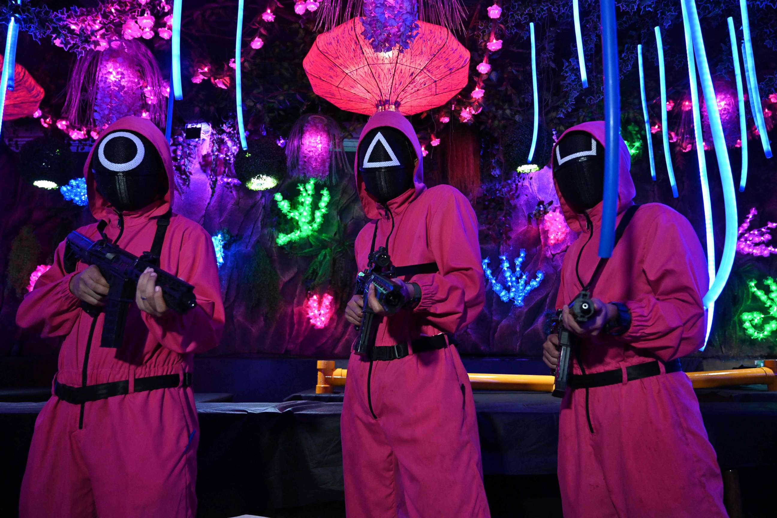 PHOTO: Waiters dressed in outfits from the Netflix series "Squid Game" pose while playing a game to attract customers at a cafe in Jakarta, Indonesia on Oct. 19, 2021.